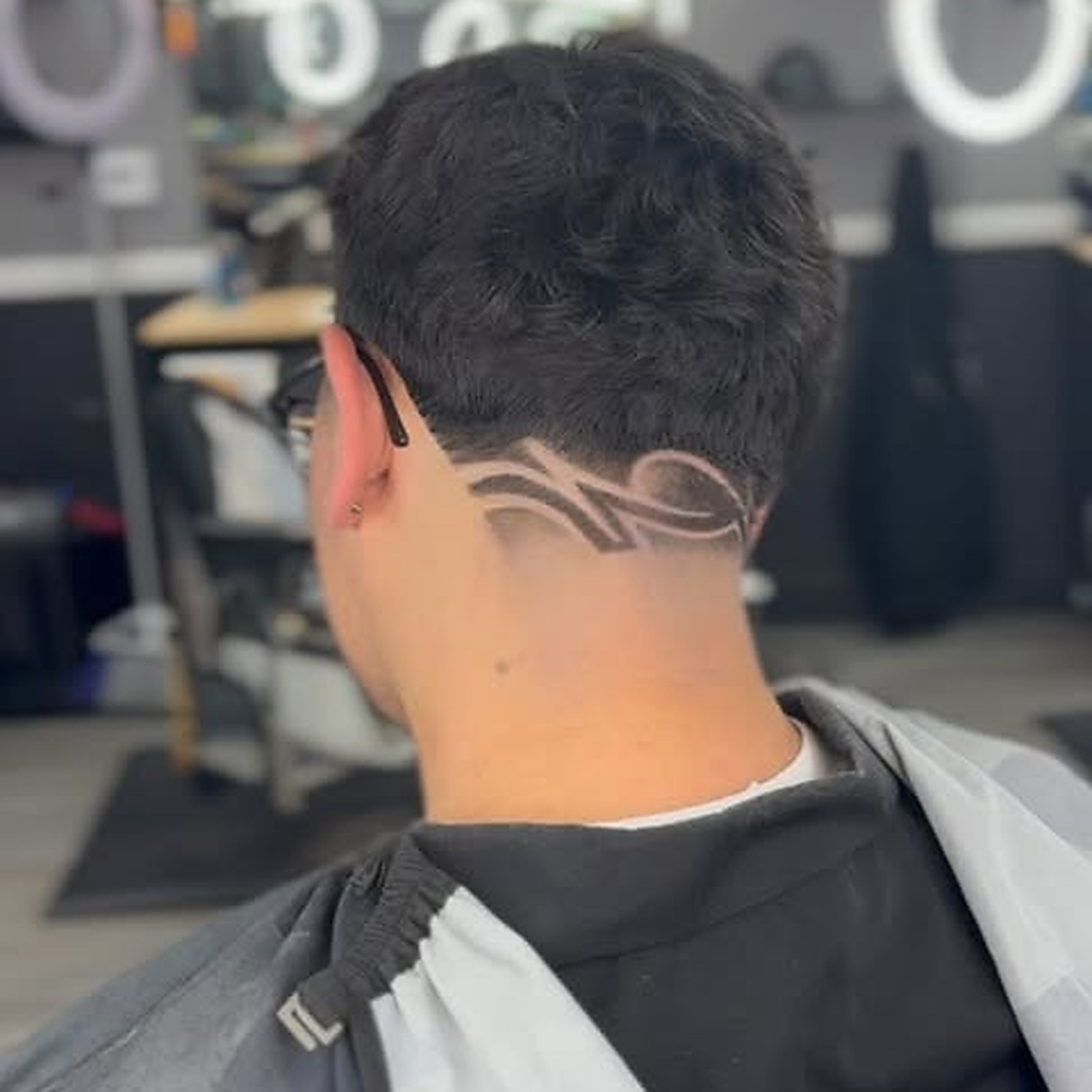 Freestyle design — Pattern cut freehand into the taper behind the ear