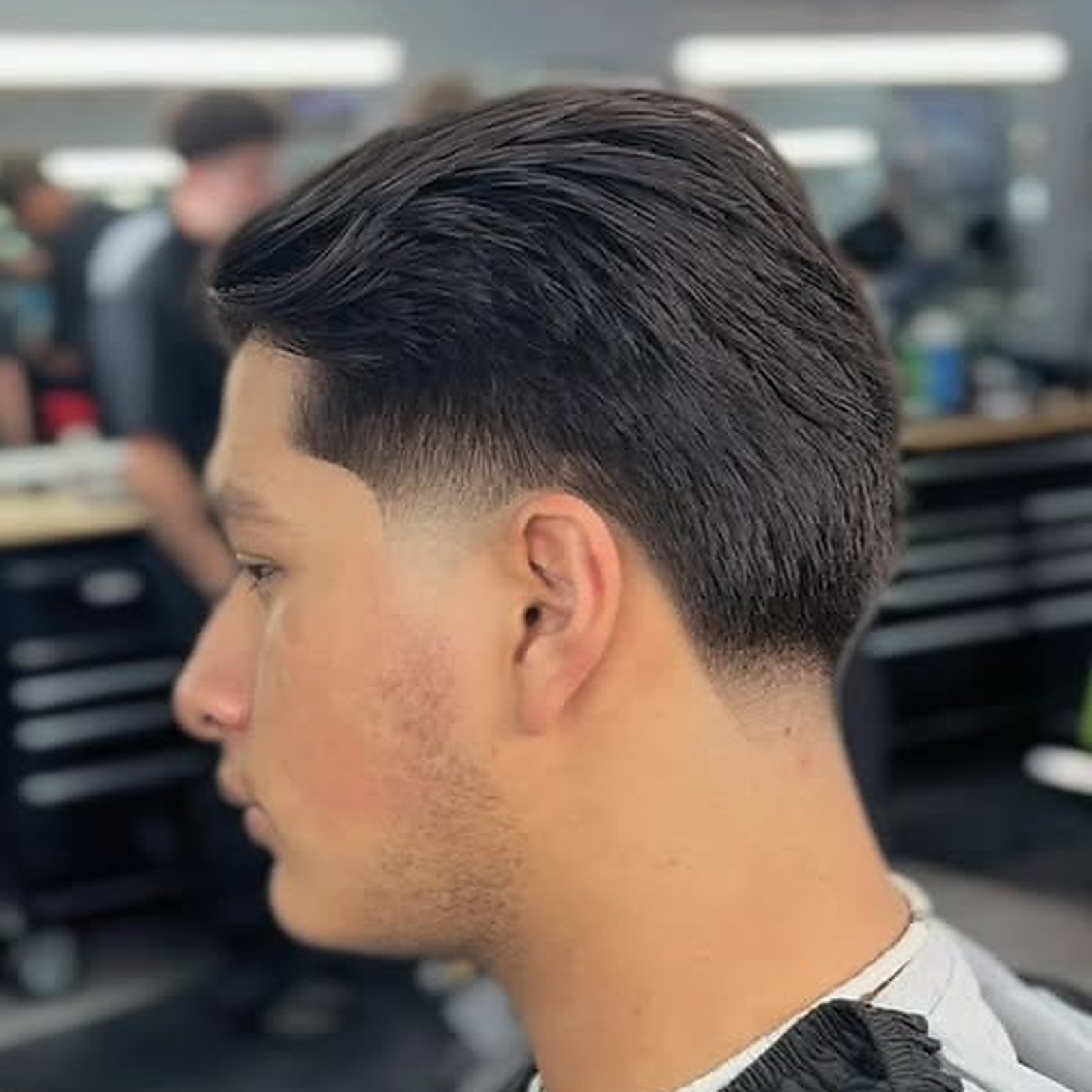 Slick back taper — Length pushed back, low taper kept tight around the ear